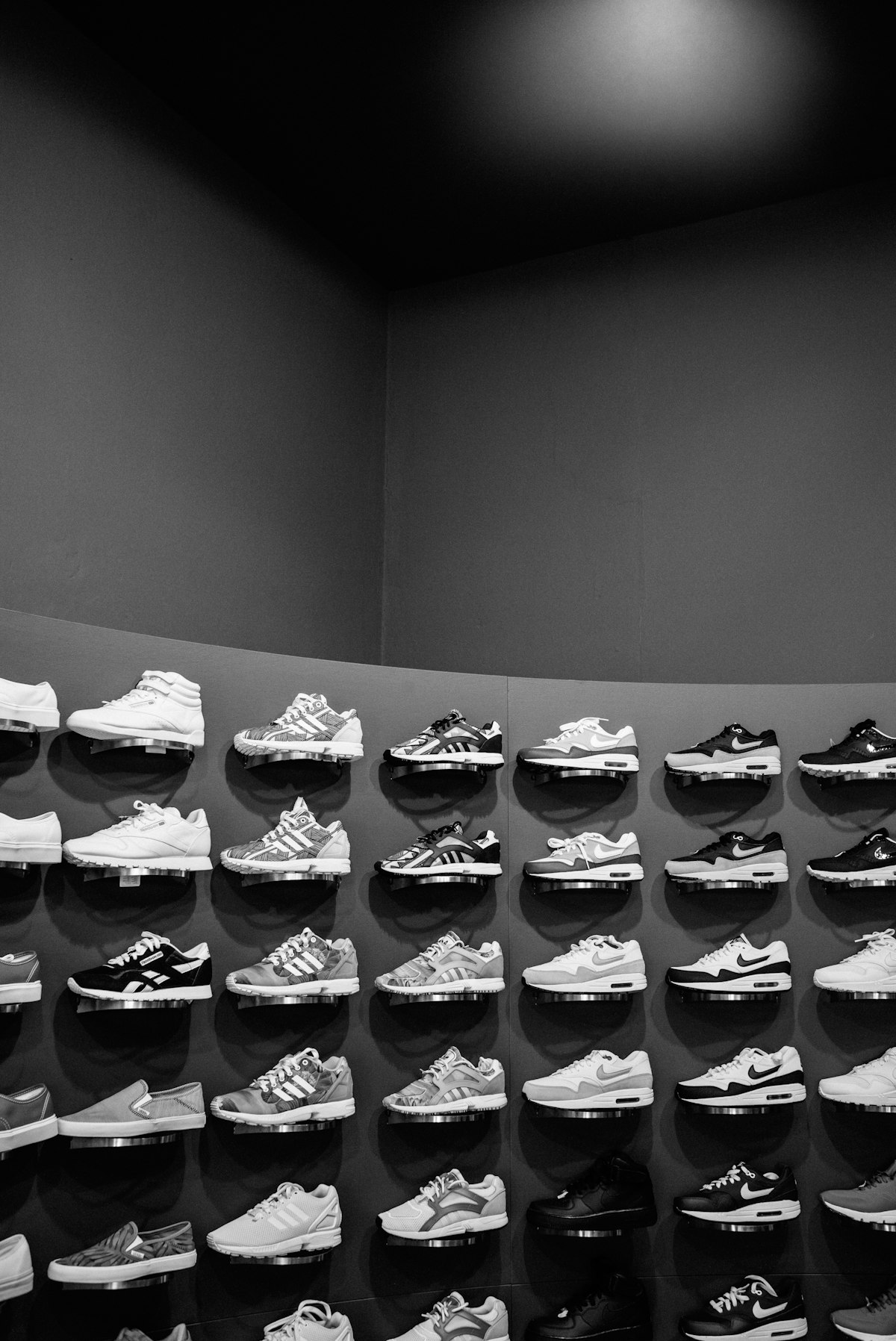 A large display of sneakers in black and white